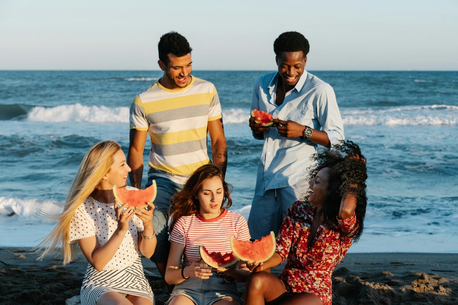 Friends relaxing together beside the sea