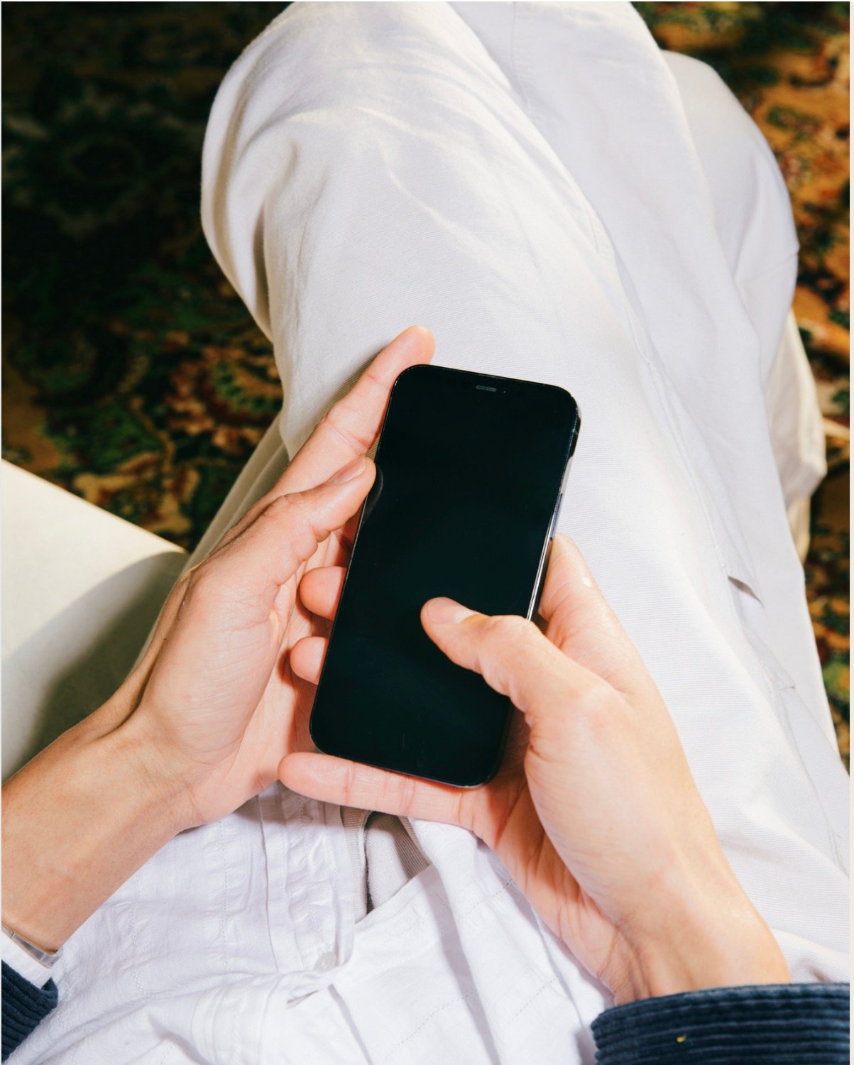 Person holding a phone during a private conversation