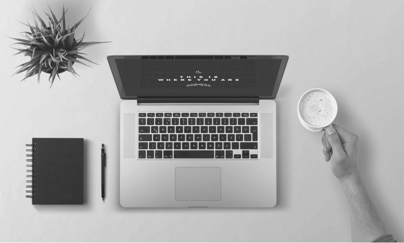 Laptop, notebook and coffee on a desk